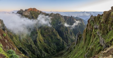 Sunrise at Pico do Arieiro, clouds of fog pass over mountain peaks, hiking trail PR1, Madeira,