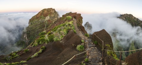 Sunrise at Pico do Arieiro, clouds of fog sweep over mountain peaks, sea of fog, hiking trail PR1,