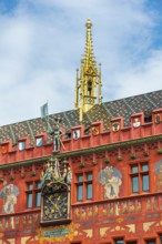 Exterior view with a magnificent clock at the Red Town Hall, Market Square, Basel