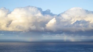 Rainbow over sea, dark rain cloud, rain, Madeira, Portugal