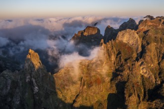 Aerial view, sunrise at Pico do Arieiro, clouds of fog sweeping over mountain peaks, Madeira,