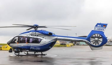 Helicopter from the Baden-Württemberg Police team in front of the hangar at the airport. Airbus