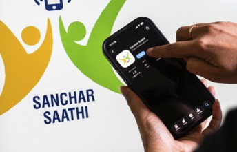 In this photo illustration, a person downloads the Sanchar Saathi mobile application on an iPhone,