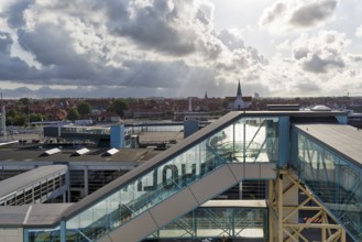 Ferry terminal, harbor with cityscape, St. Nicholas Church, dramatic cloudy sky, sunbeams, Rønne,