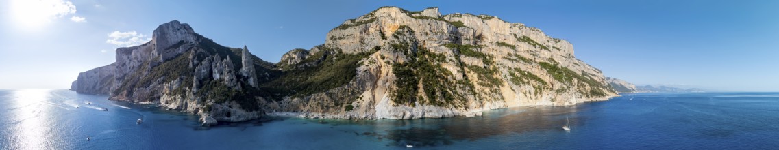 Panorama, picturesque rocky coast, cliffs with L'Aguglia pinnacle, blue sea and Cala Goloritzé