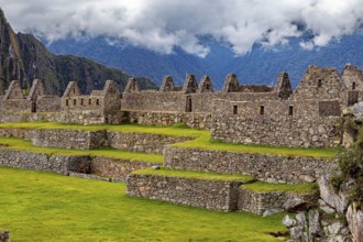 Ruins of Machu Picchu with clear contours against a cloudy sky, The ruins of the Inca city of Machu