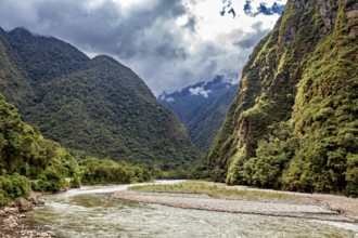 Winding river path through a lush green valley, The Urubamba Valley near Machu Picchu in Peru