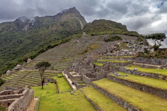 Nested Inca terraces and walls in front of picturesque mountains in Machu Picchu, The ruins of the