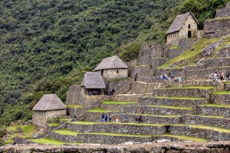 Traditional Inca huts and terraces on a green mountainside near Machu Picchu, The ruins of the Inca