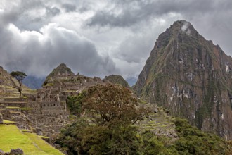 Mystical atmosphere above the ruins of Machu Picchu surrounded by clouds and mountains, The ruins