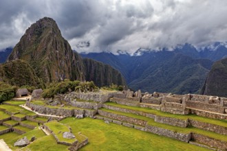 View of Machu Picchu with a mix of ruins and green terraces, The ruins of the Inca city of Machu