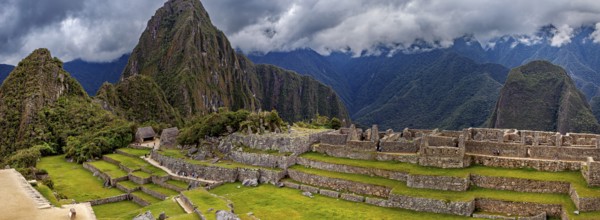 Panorama of Machu Picchu with mountains in the background and thick cloud sky, The ruins of the