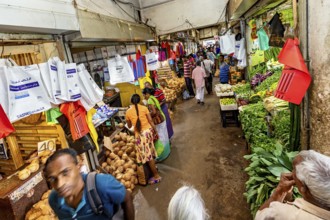 Lively market scene with customers, bags and fresh goods, dealers in the market halls of Kandy Sri