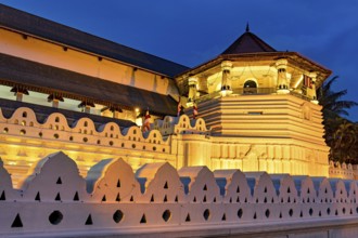 Night view of a historically illuminated building with geometric patterns, The Temple of the Tooth