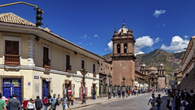 Historic city scene with colonial architecture and busy street life under blue skies, The churches