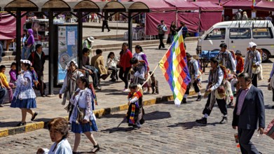 People wearing traditional clothes with colorful flags on a street, traditional parade of festival