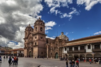 Magnificent church on a large square, lively with people and surrounded by numerous clouds, The