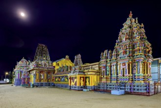 Colourful temples at night in moonlight with artfully designed reliefs, The Sri Pathrakali Amman