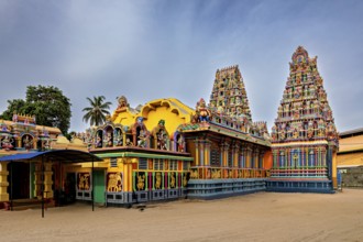 Hindu temple with colorful sculptures and traditional architecture under clear skies, The Sri