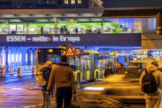 The main train station in Essen, blue illuminated underpass, bus station, am Europaplatz, train on