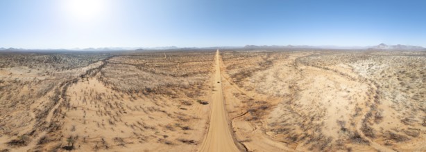 Travel, aerial view, car driving on road through arid landscape, Kunene region, Namibia