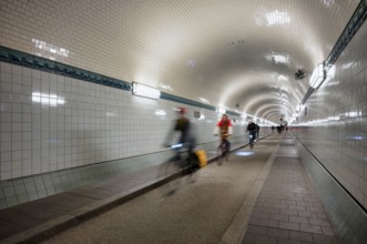 Interior view, pedestrians and cyclists crossing tunnel, mopping effect, movement, tube, historic