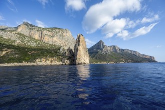 Picturesque rocky coast, cliffs with Pedra Longa pinnacle, blue sea, Golfo di Orosei, Baunei,
