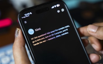 In this photo illustration, a person uses the Kimi AI chatbot on a smartphone, in New Delhi, India