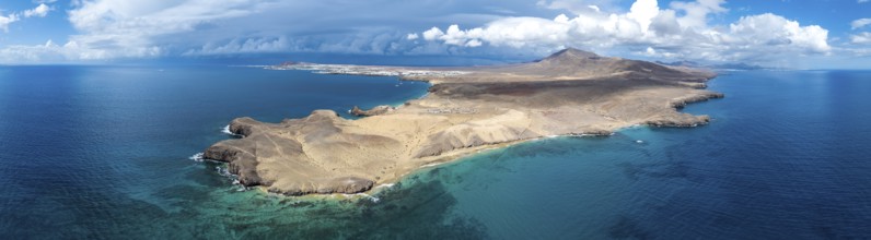 Headland and blue sea, coastal landscape, arid landscape of Los Ajaches Natural Park, aerial view,
