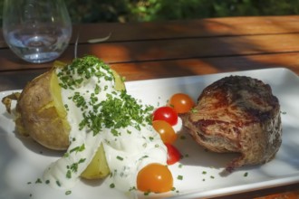 Rump steak, slice of beef, baked potato with quark, herbs, cherry tomatoes, chives, food
