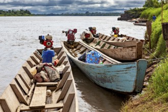 Wooden boats with motors on the river under cloudy sky, longboat on a river near Rurrenabaque in
