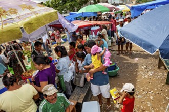 Lively market with lots of people, colorful umbrellas and a variety of goods, The Rurrenabaque