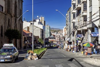 City street in everyday life with cars and passers-by between multi-storey buildings, The city of