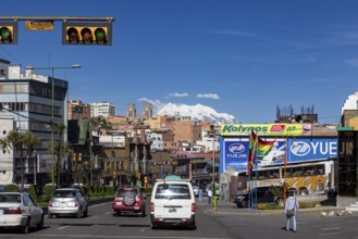 Urban street with traffic and billboards, mountains can be seen in the background, The city of La