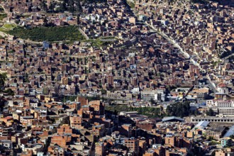 Dense urban development with many brick buildings in hilly surroundings, the city of La Paz in