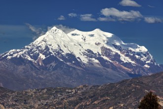 Snow-capped mountain with clear skies and rocky landscape that exudes a calm and majestic