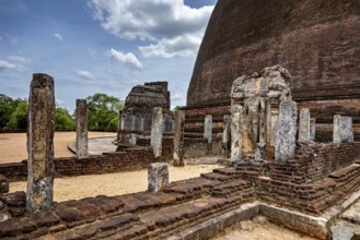 Architectural details and ruins of an ancient site next to a large stupa, The Temples of