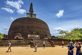 Large ancient stupa with people in the foreground on a sunny day, The temples of Polonnaruwa in Sri