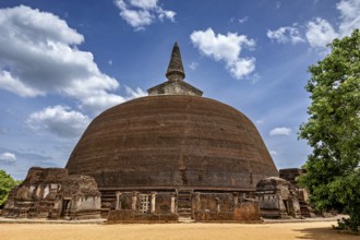 Large stupa under a cloudy sky with surrounding ancient walls, The temples of Polonnaruwa in Sri