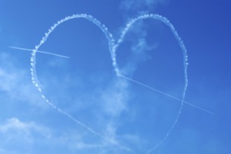 The Indian Air Force aerobatic team performs during an air show as part of the 93rd Air Force Day