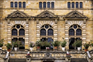 Architectural details with floral arrangements in front of magnificent castle windows, The