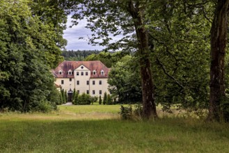 A manor house nestled in trees and meadows, idyllic rural ambiance, The Hummelshain hunting lodge