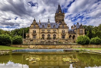 A majestic castle with mirror lake and cloudy sky, The Hummelshain hunting lodge in Thuringia