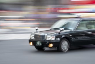 Black taxi driving, motion blur, long exposure, Shubuya Crossing, Shibuya, Tokyo, Japan