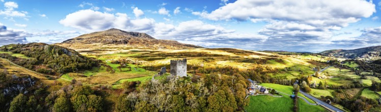 Autumn colours over Castell Dolwyddelan and Eryri Mountains from a drone, Snowdonia, Conwy County