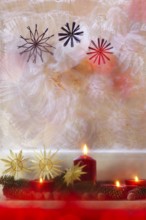 Christmassy decorated iced window, candle light, straw stars, Germany