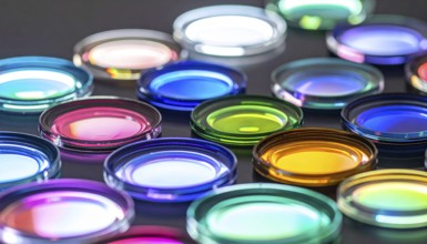Abstract background of slightly unfocused multicolored glass lenses spinning and rotating,