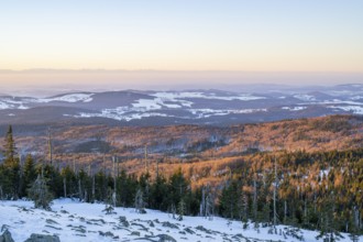 View from Mount Lusen over the hills of the bavarian forest at sunrise in winter, Bavaria, Germany