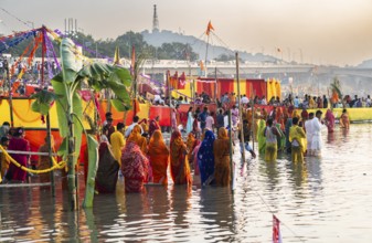 Hindu devotees gather on the banks of the Brahmaputra River to offer prayers to the Sun God on the