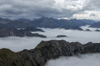 View from the Nebelhorn summit to mountains of the Allgäu Alps, mountains rising from fog in the